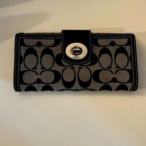 Coach signature double sided wallet with silver turn lock.